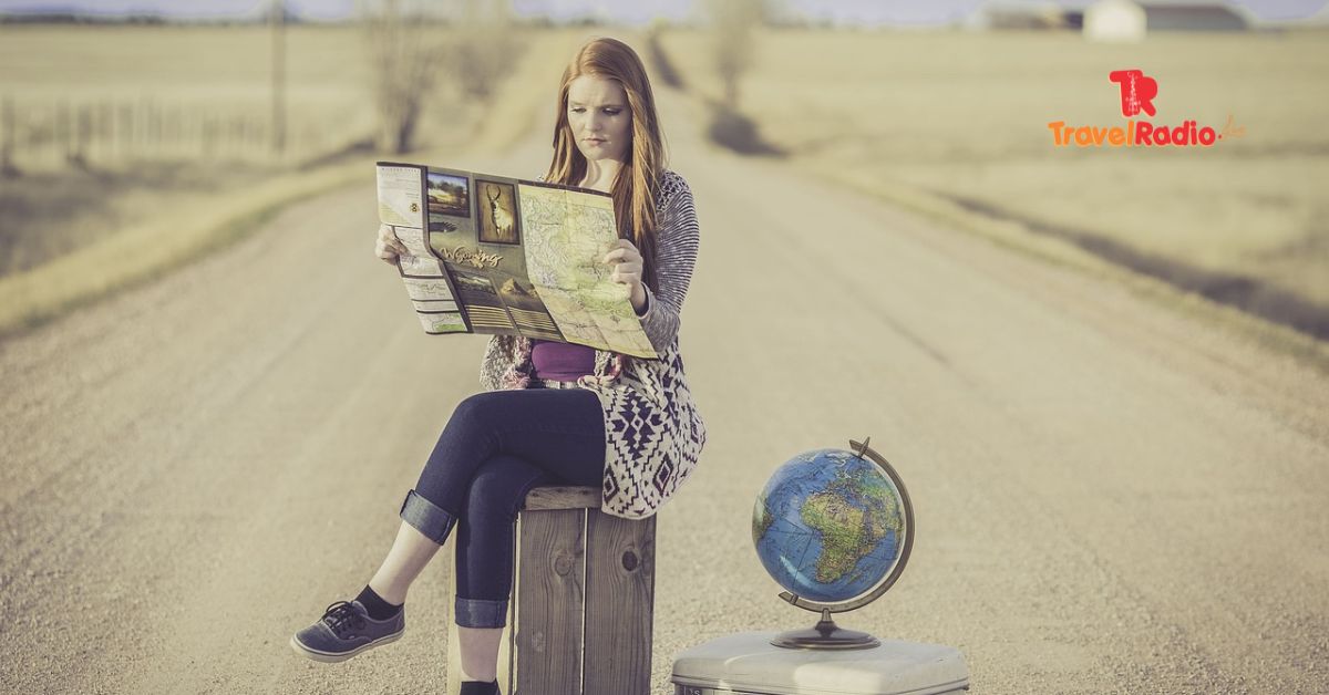 lady in midddle of road reading map