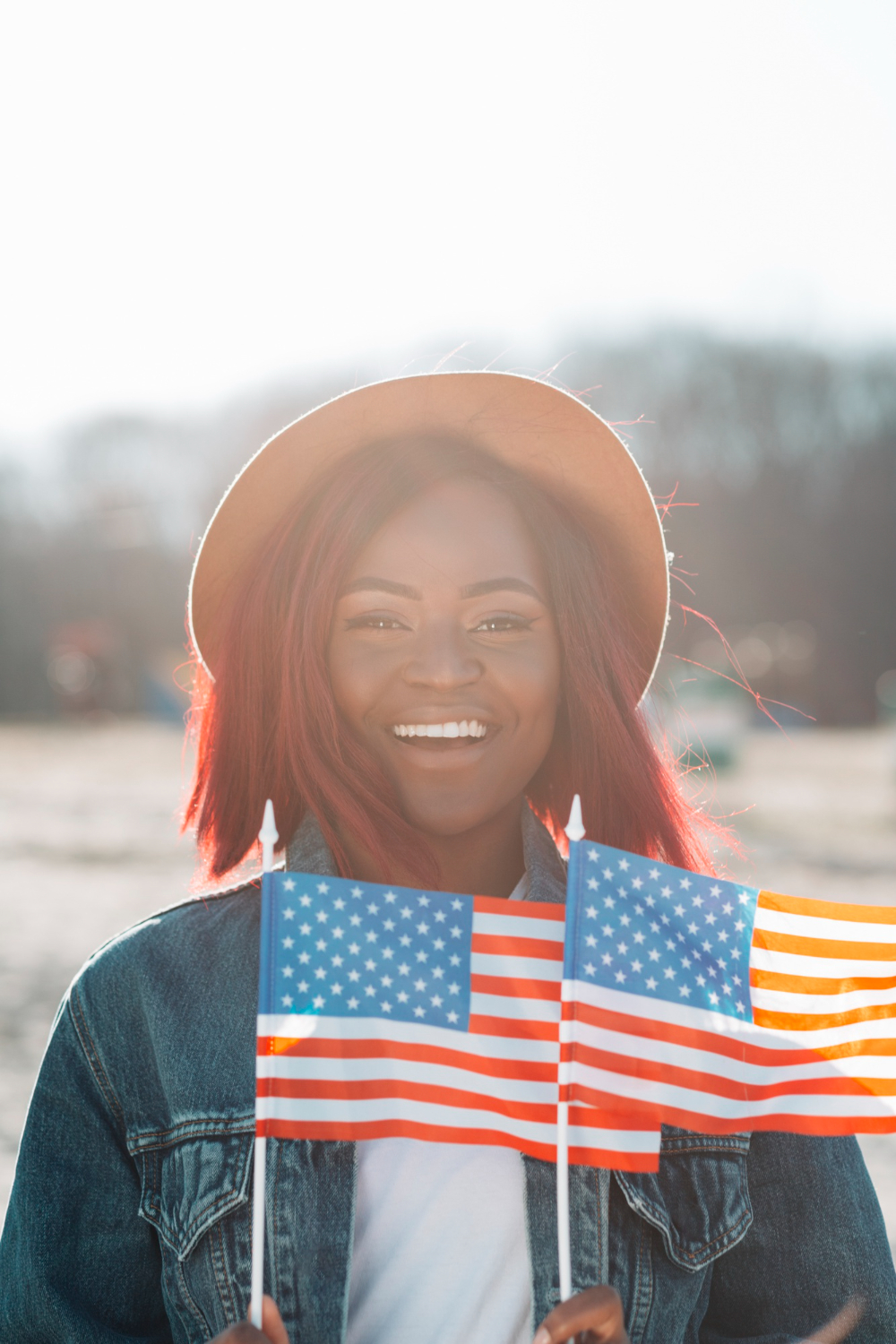 The image below shows an African American citizen holding the U.S. flag. 