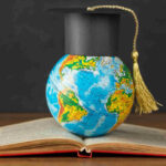 An image showing a graduation cap on a globe, symbolizing global education and study abroad.