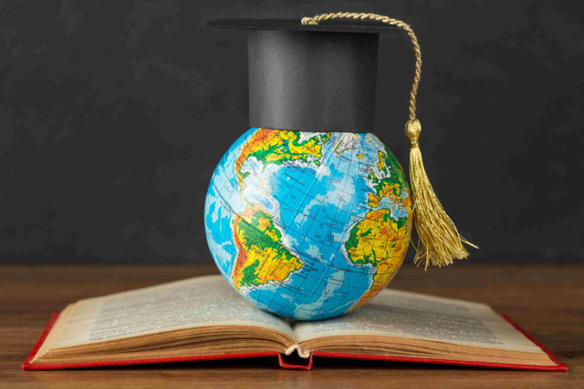 An image showing a graduation cap on a globe, symbolizing global education and study abroad.