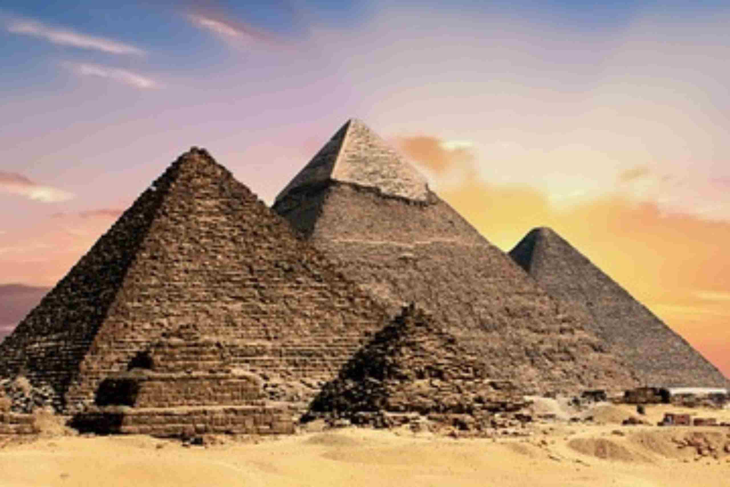 The Pyramids of Giza in the Egyptian desert during sunset.