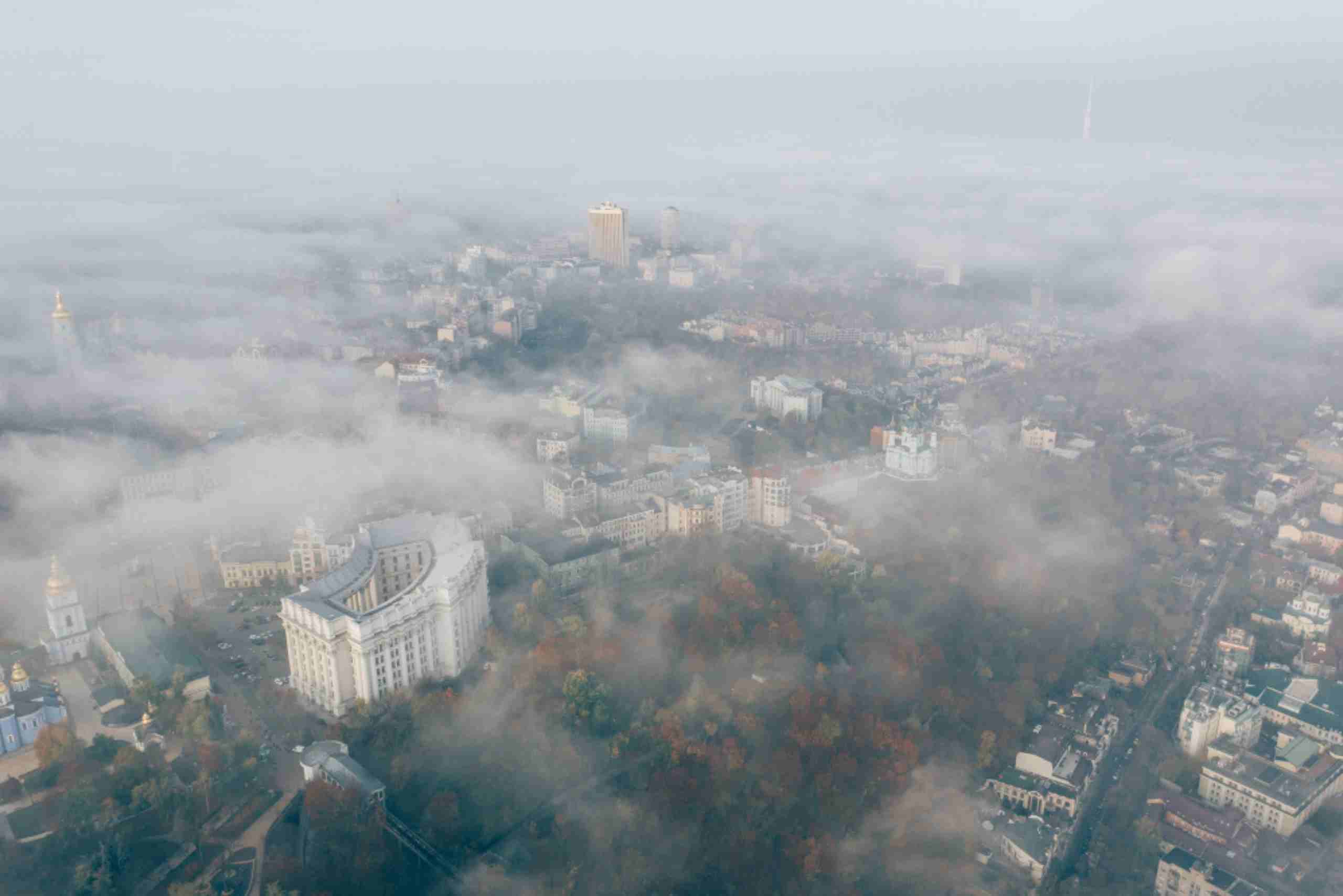 An image showing an aerial view of a city blanketed in a thick haze.