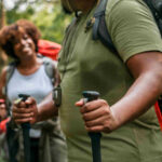 An image showing a couple trekking in the forest.