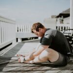 man doing yoga in porch